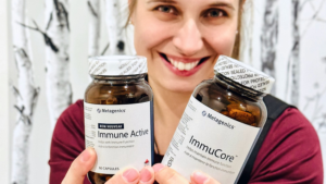 Une femme tenant deux flacons de suppléments naturels pour soutenir le système immunitaire