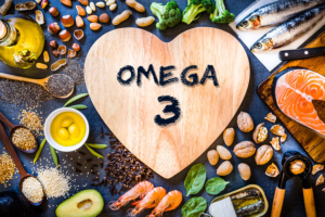 Image d'aliments contenant des oméga-3 avec un coeur en bois marqué omega 3 au centre